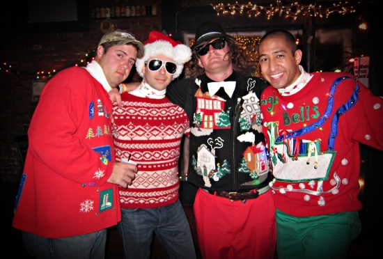 Four guys in ugly Christmas sweaters