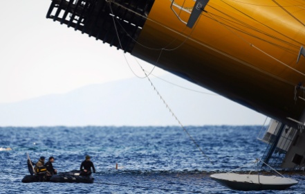 Rescuers check the sea near the Costa Concordia on January 15, 2012, after the cruise ship ran aground the night before. (Filippo Monteforte/AFP/Getty Images)