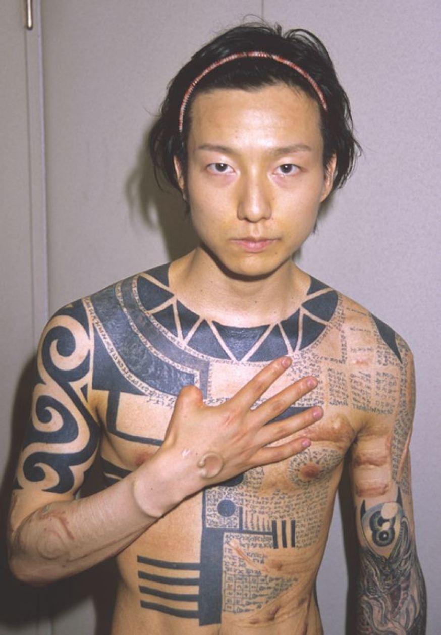 Man showing his body modifications Japan 1