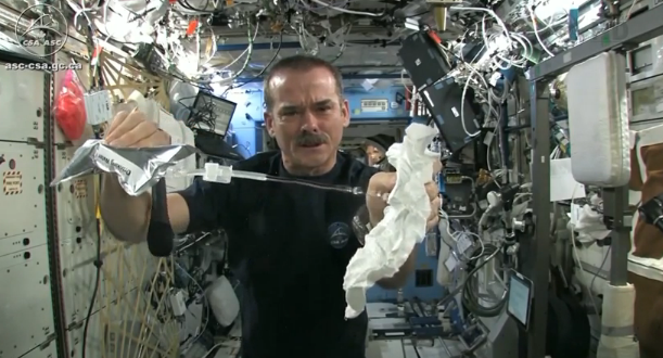 Wringing a washcloth out in space zero gravity